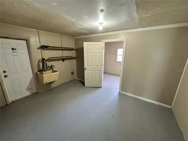 a view of a storage & utility room with refrigerator