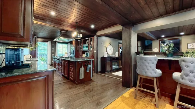 a kitchen with granite countertop stainless steel appliances and wooden cabinets