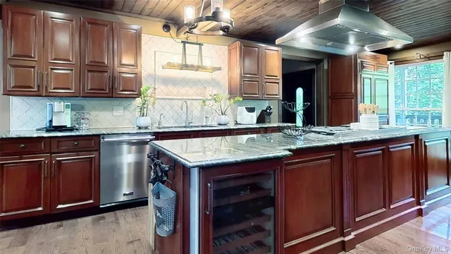 a kitchen with kitchen island granite countertop a sink and a counter
