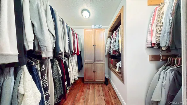 a spacious bedroom with a bed a couch and dresser