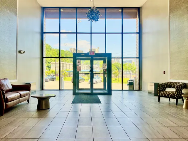 a view of swimming pool with outdoor seating and house in the background