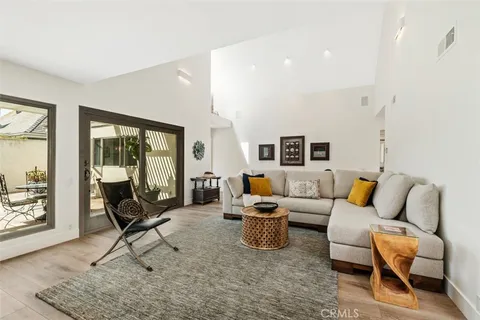 a living room with furniture and a floor to ceiling window