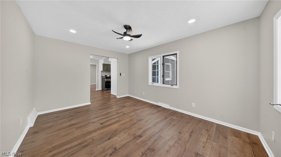 16811 Invermere Avenue Cleveland, OH 44128 - Photo 21 of 47 Empty room with dark wood finished floors, a ceiling fan, and recessed lighting