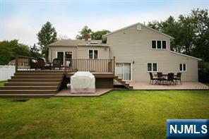 9 Gibbs Road Dumont, NJ 07628 - Photo 18 of 21 a front view of a house with a garden and patio