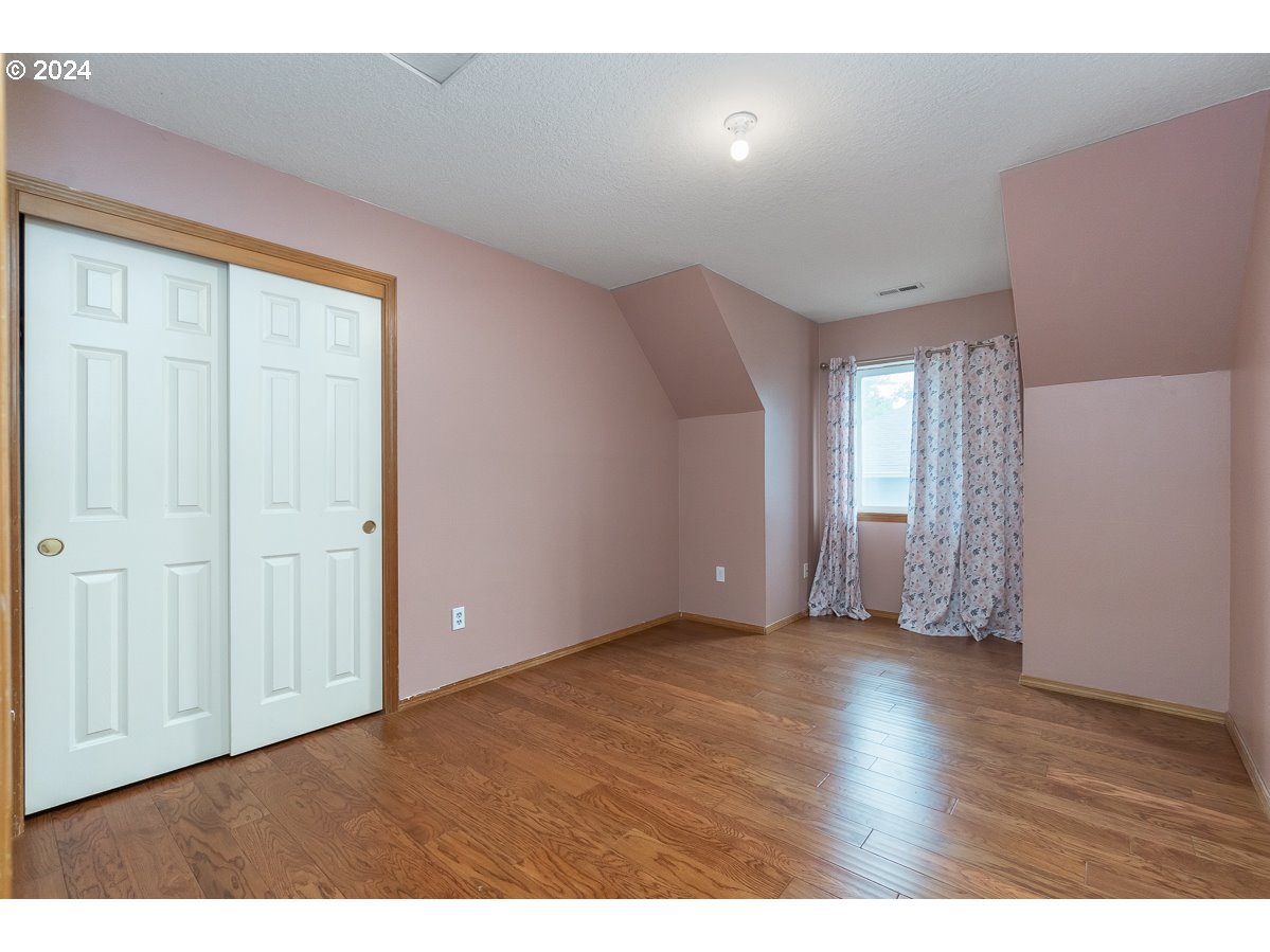 7822 Southwest 171st Place Beaverton, OR 97007 - Photo 12 of 20 a view of an empty room with wooden floor