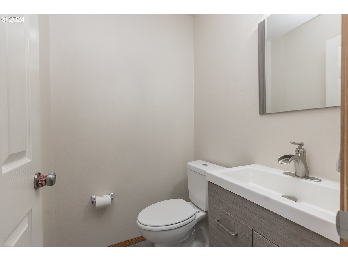 7822 Southwest 171st Place Beaverton, OR 97007 - Photo 16 of 20 a bathroom with a toilet a sink and mirror