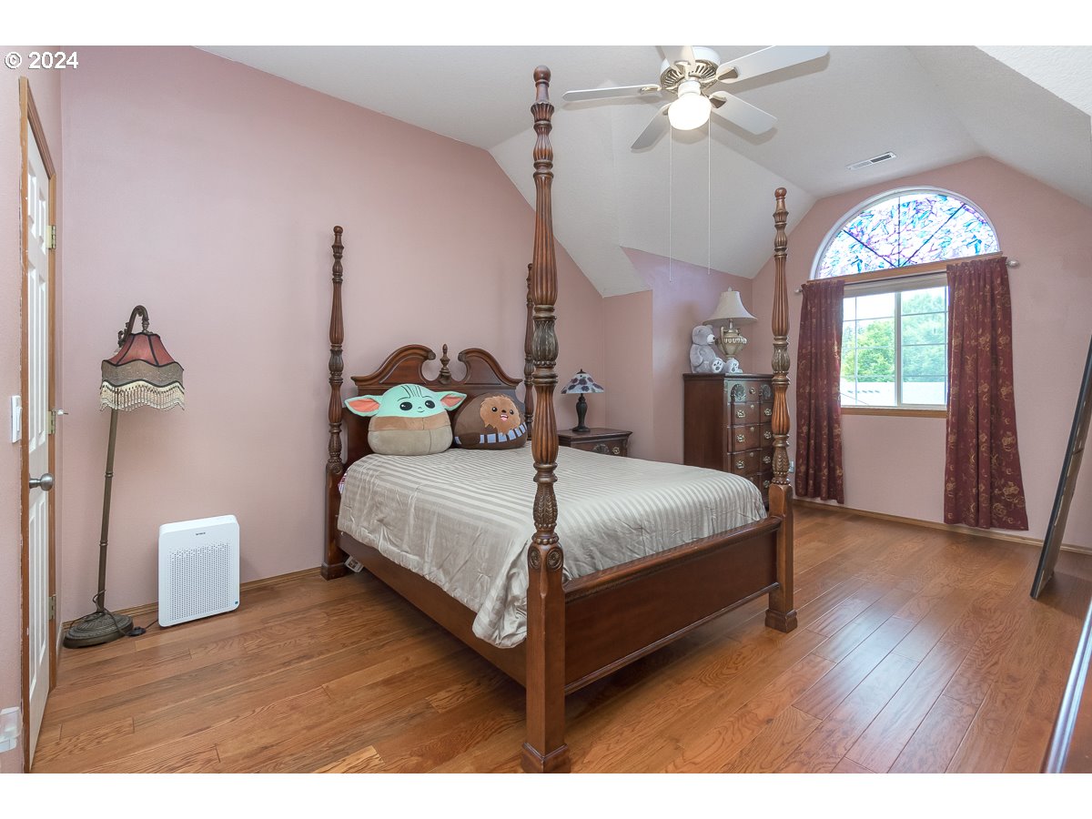 7822 Southwest 171st Place Beaverton, OR 97007 - Photo 17 of 20 a bedroom with a bed and a chandelier