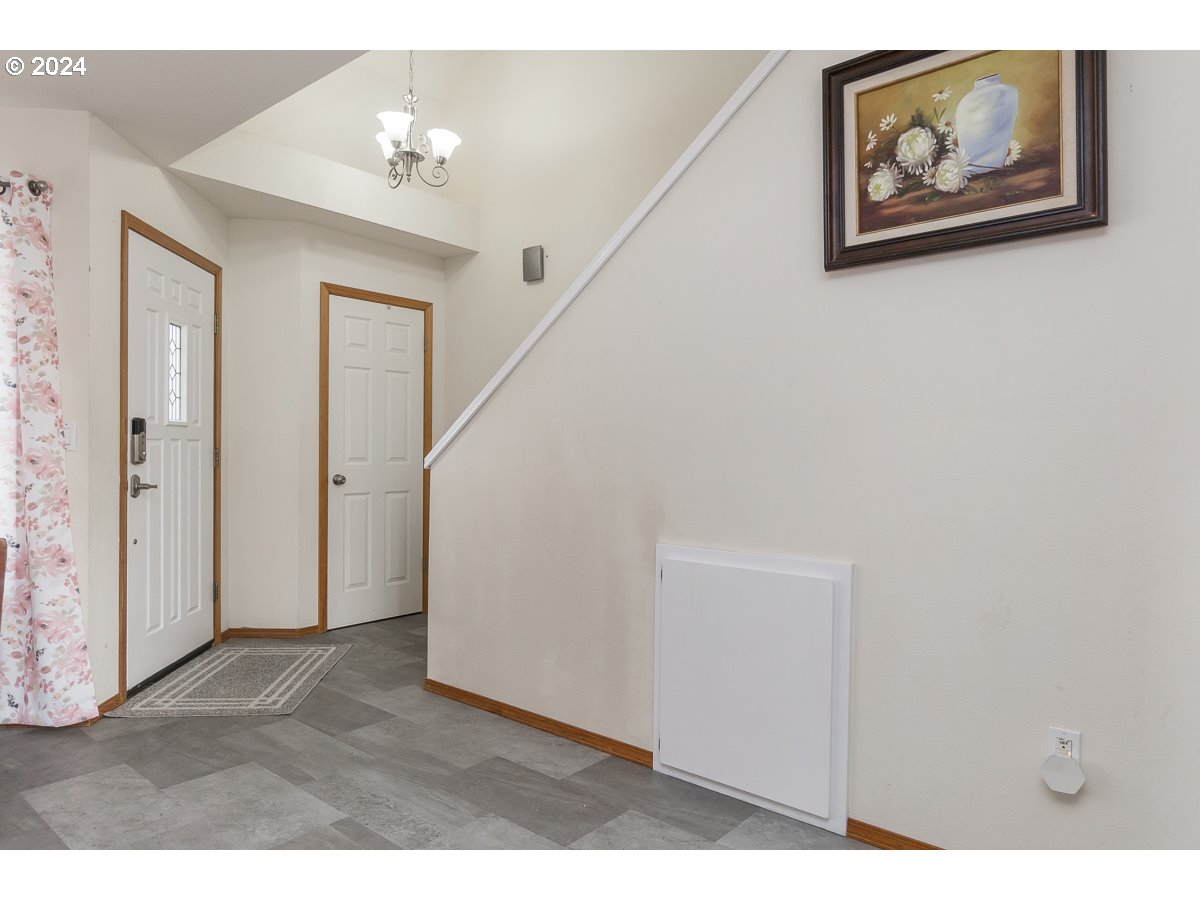 7822 Southwest 171st Place Beaverton, OR 97007 - Photo 4 of 20 a view of a hallway with paintings on the wall