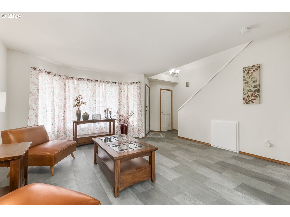 7822 Southwest 171st Place Beaverton, OR 97007 - Photo 6 of 20 a living room with furniture and a wooden floor