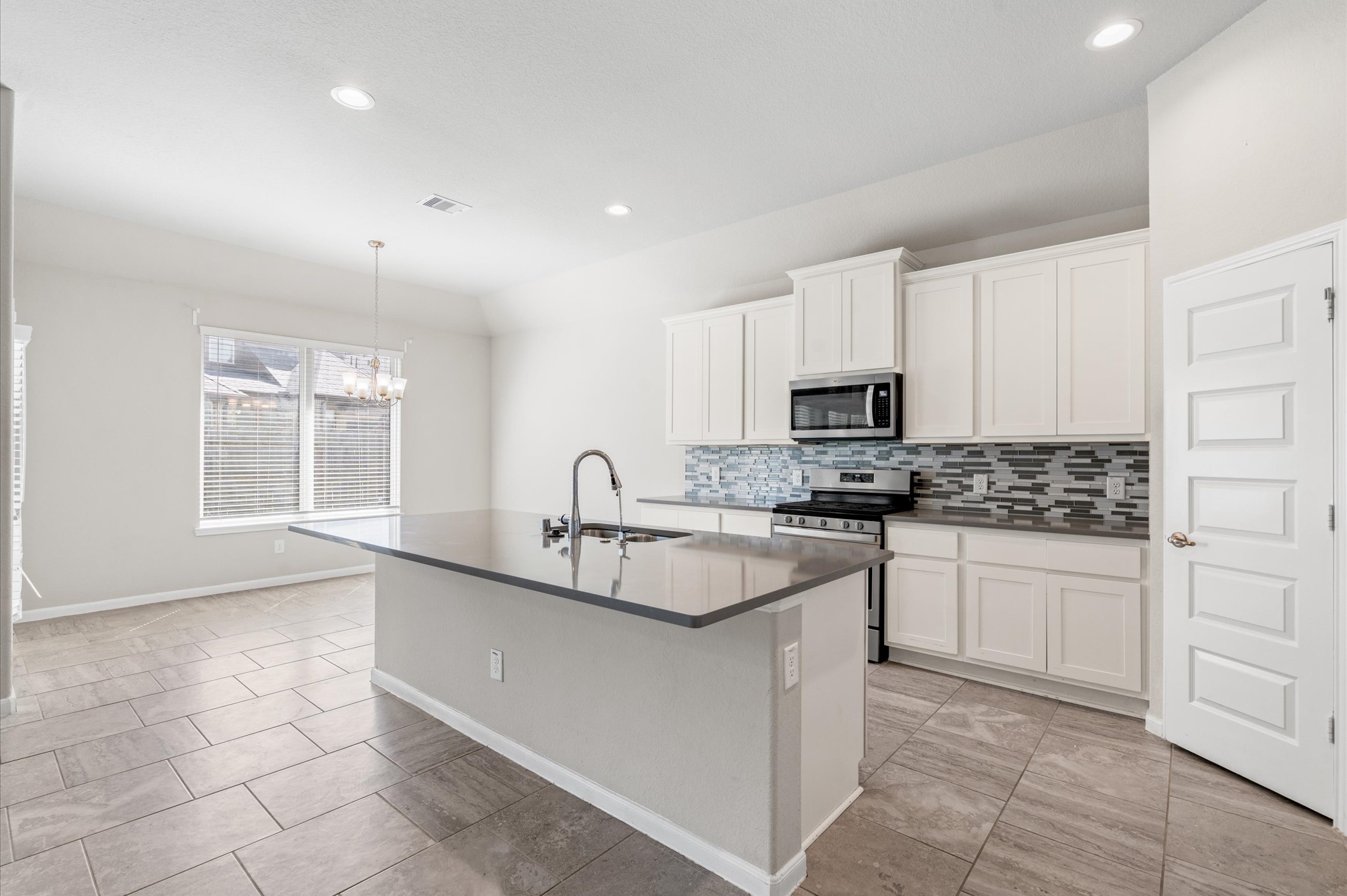 410 Richfish Run Drive Rosenberg, TX 77469 - Photo 10 of 30 Modern kitchen with elegant granite countertops, sleek stainless steel appliances, and a spacious pantry.