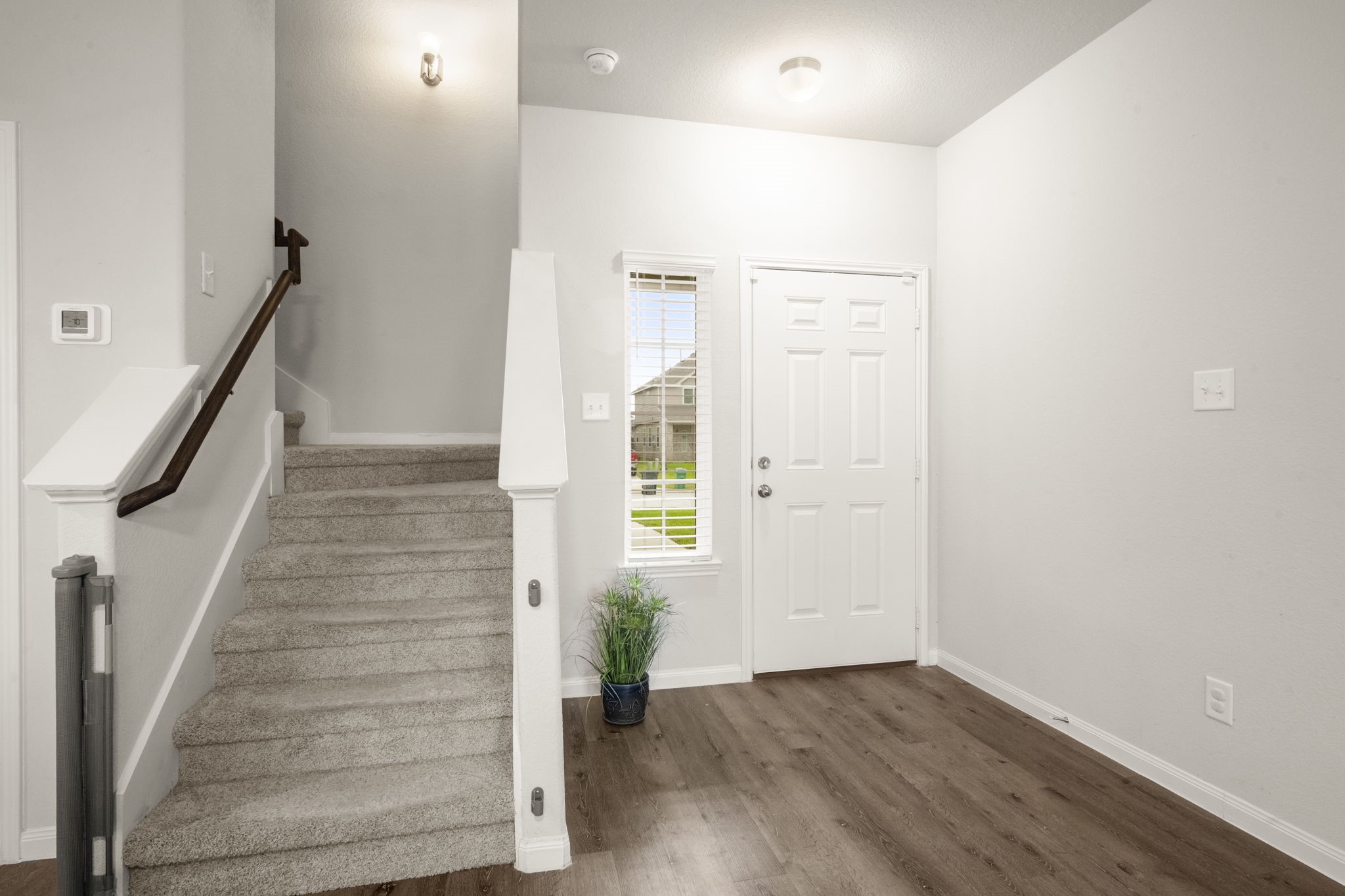 4915 Blue Jacaranda Way Spring, TX 77373 - Photo 3 of 30 Bright and welcoming foyer features neutral walls, LVP wood flooring, and natural light.