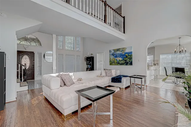 a view of a hallway with wooden floor and stairs