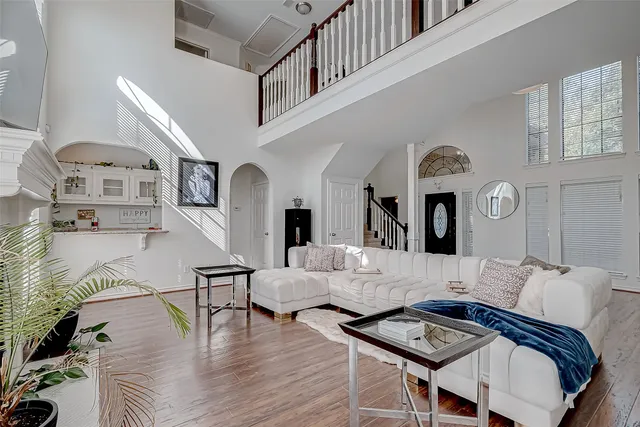 a spacious bedroom with a bed and a ceiling fan