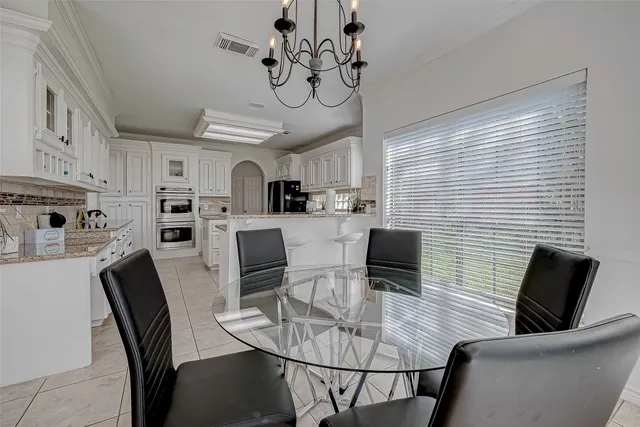 a view of a workspace with furniture and a chandelier fan