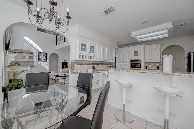 a spacious bathroom with a granite countertop sink a toilet a mirror and vanity