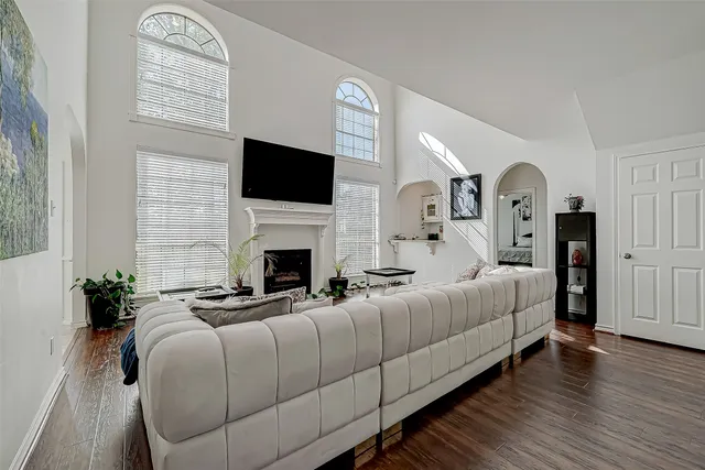 a bed sitting in a spacious bedroom next to a window