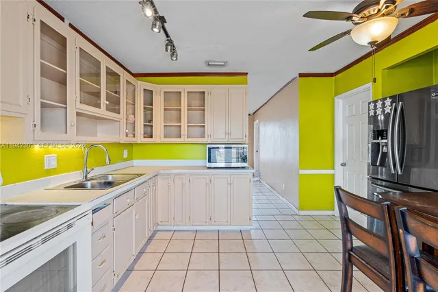 a kitchen with a sink and appliances