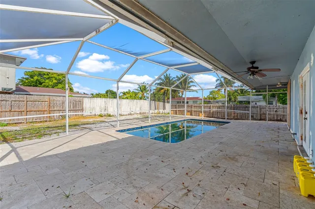 a view of a backyard with swimming pool