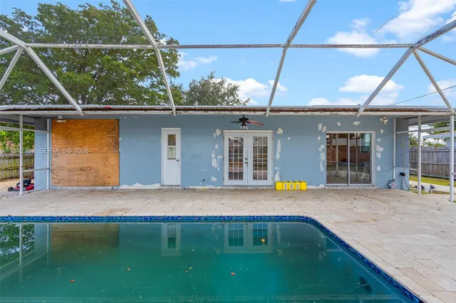 a view of a backyard with a tub and wooden fence