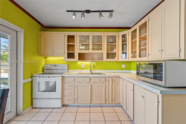 a view of a kitchen with a sink and dishwasher next to a window
