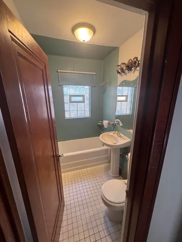 a bathroom with a sink a toilet and tub