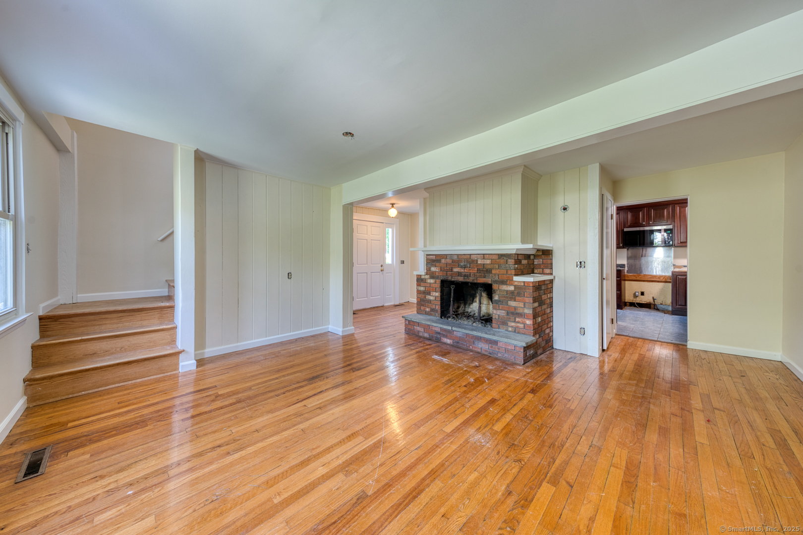134 East Street Litchfield, CT 06759 - Photo 11 of 38 a view of empty room with wooden floor and fireplace