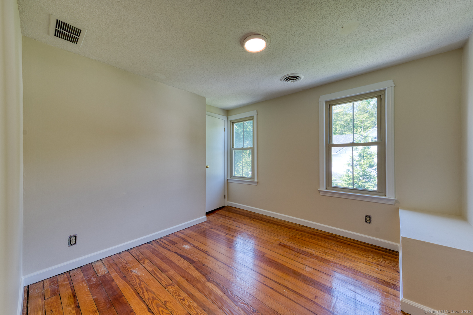 134 East Street Litchfield, CT 06759 - Photo 31 of 38 a view of an empty room with wooden floor and a window