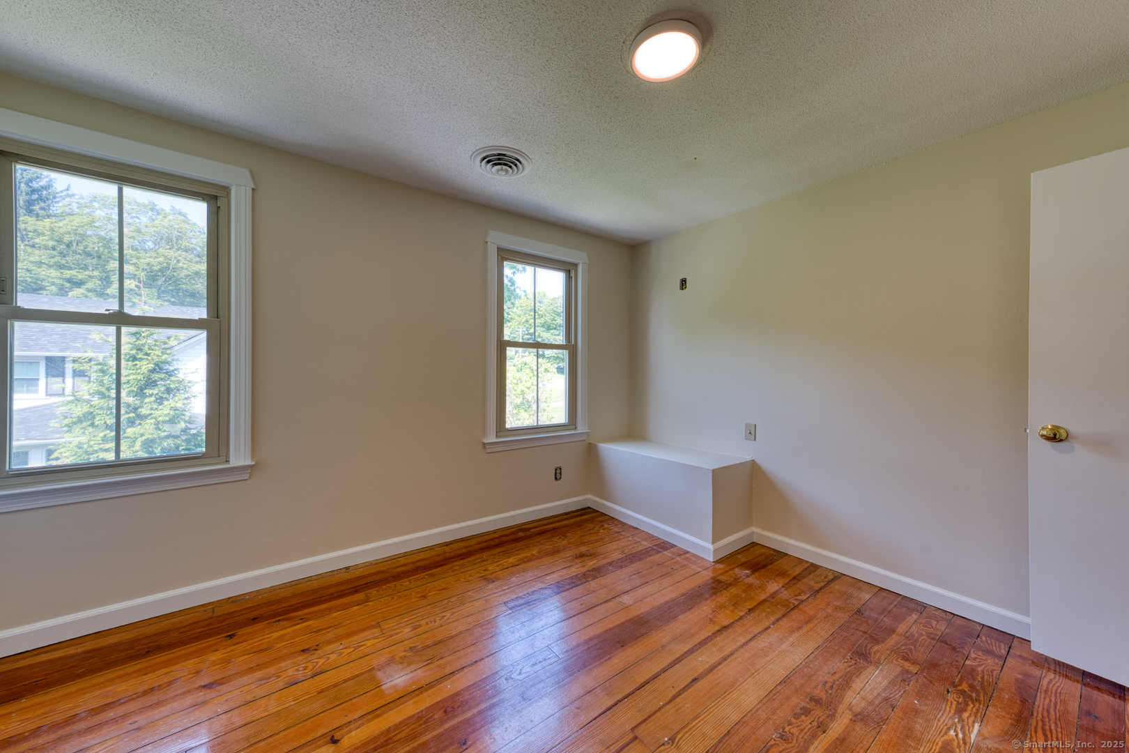 134 East Street Litchfield, CT 06759 - Photo 32 of 38 a view of an empty room with wooden floor and a window
