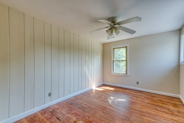 a view of a livingroom with a ceiling fan and window