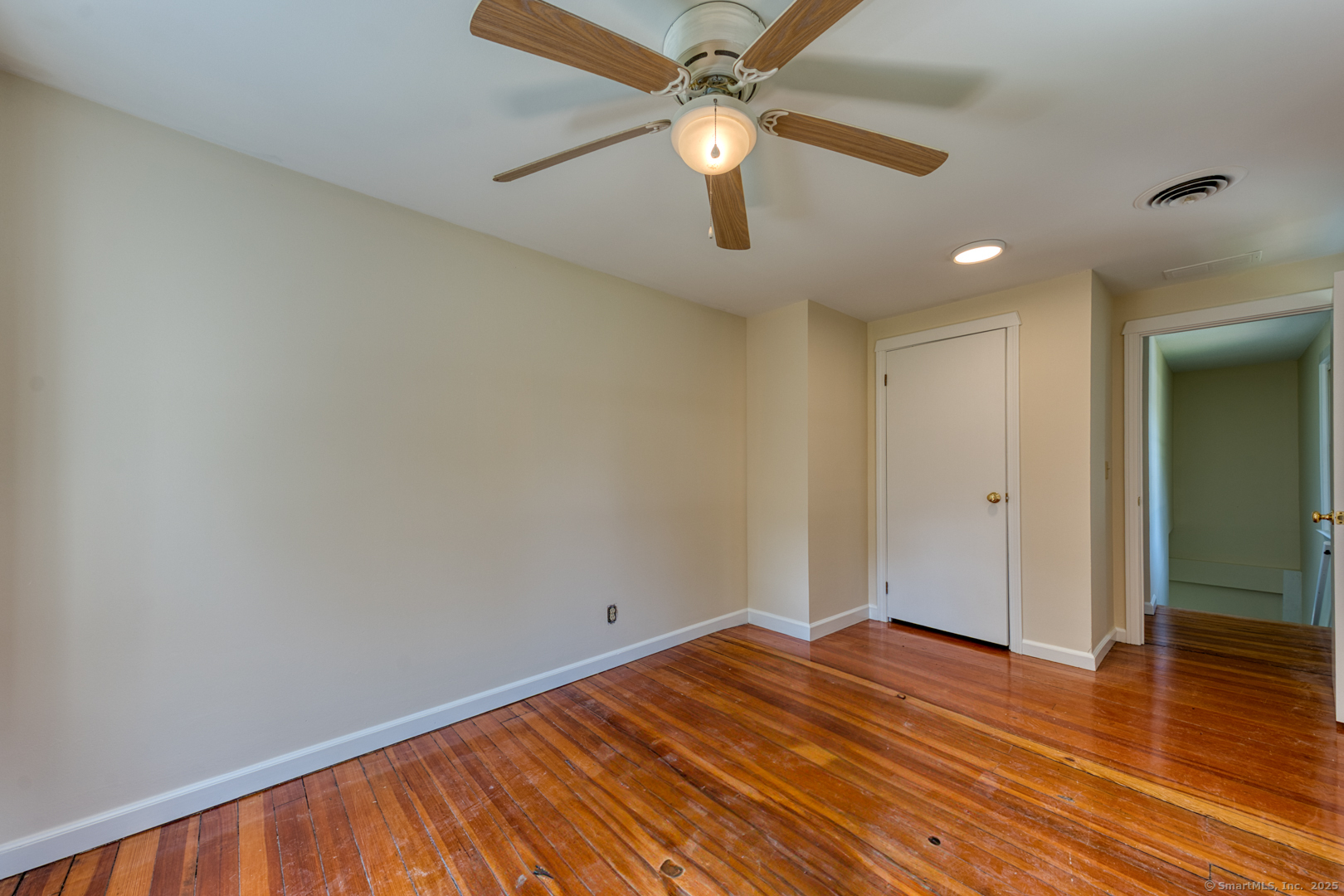 134 East Street Litchfield, CT 06759 - Photo 35 of 38 an empty room with wooden floor fan and windows