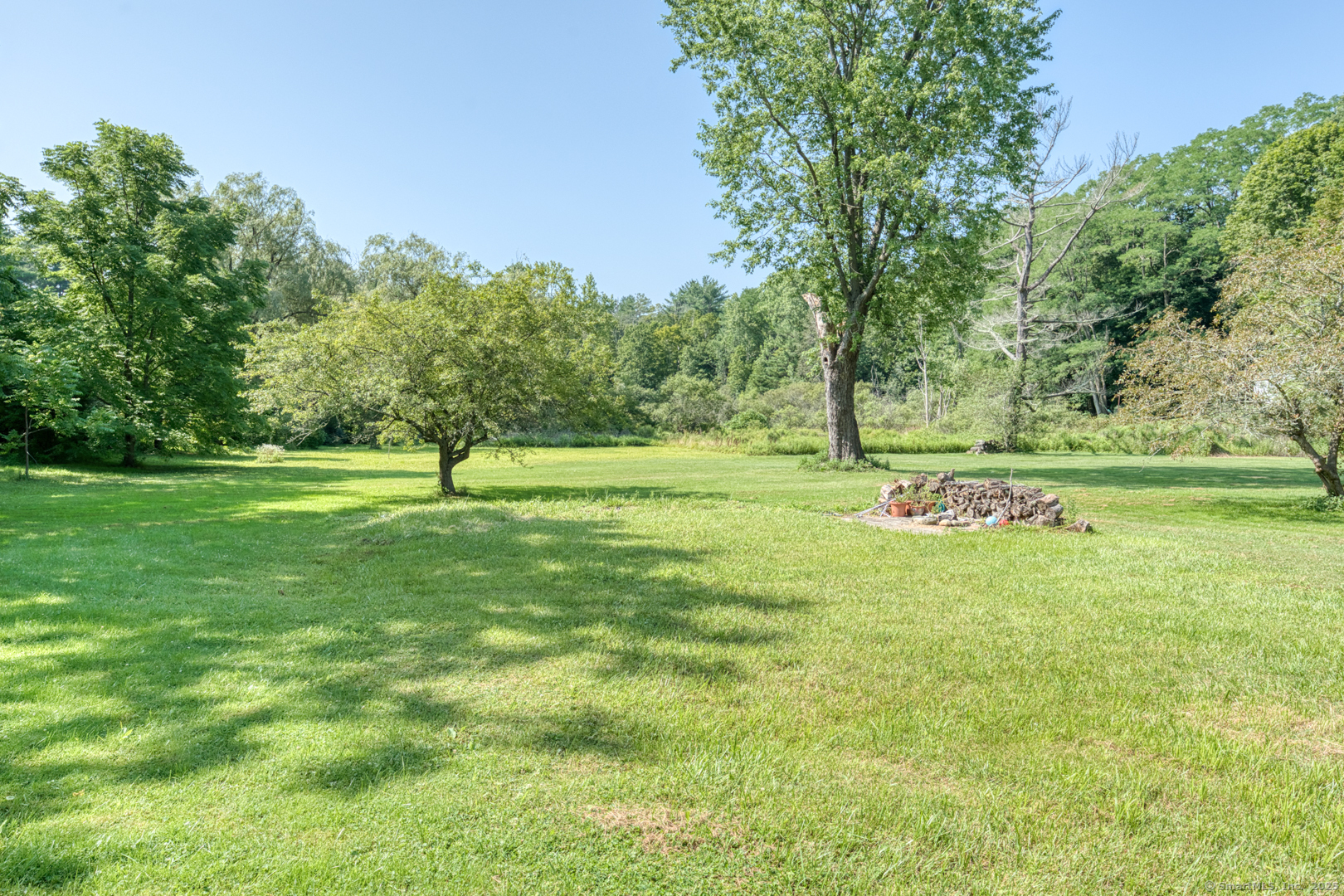 134 East Street Litchfield, CT 06759 - Photo 7 of 38 a view of a grassy field with trees