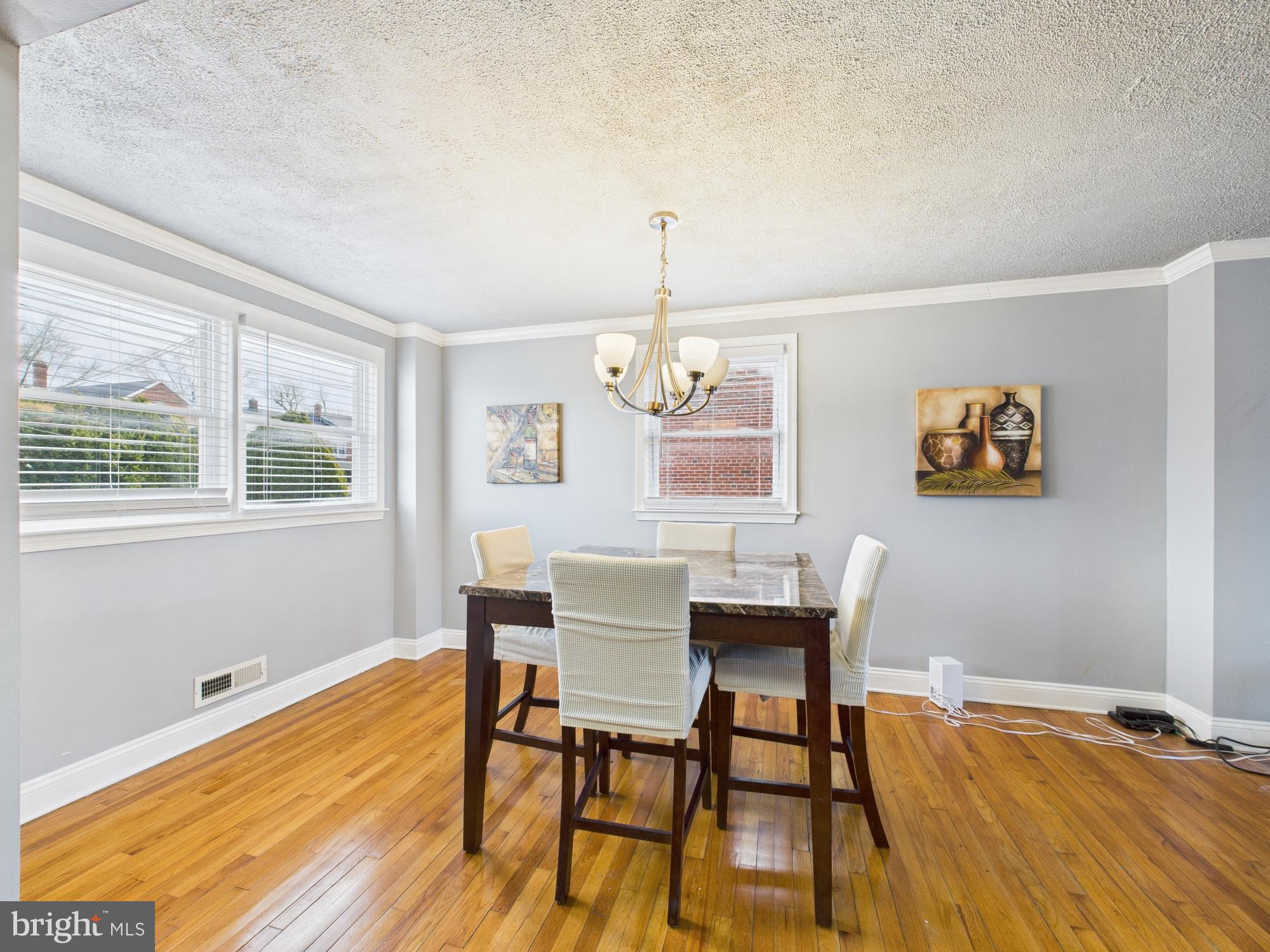 1551 Langford Road Baltimore, MD 21207 - Photo 11 of 52 a view of a dining room with furniture a chandelier and wooden floor