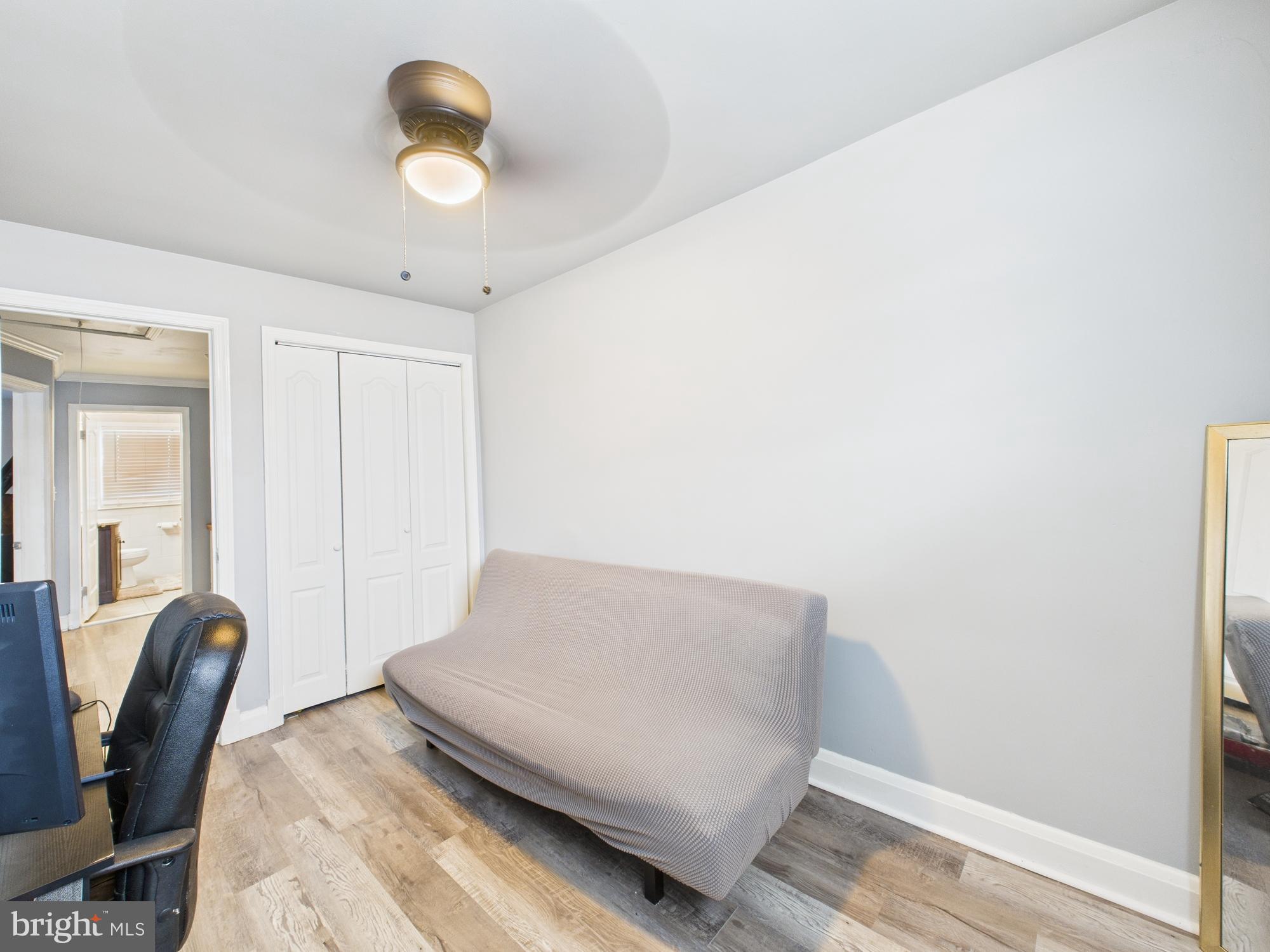 1551 Langford Road Baltimore, MD 21207 - Photo 44 of 52 a living room with furniture and a potted plant
