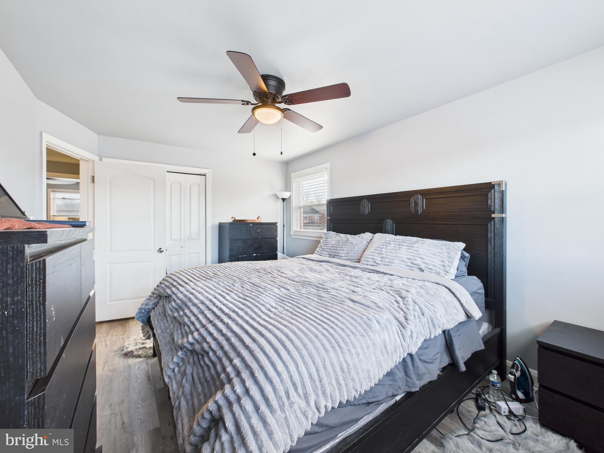 1551 Langford Road Baltimore, MD 21207 - Photo 47 of 52 a bedroom with a bed and a chandelier