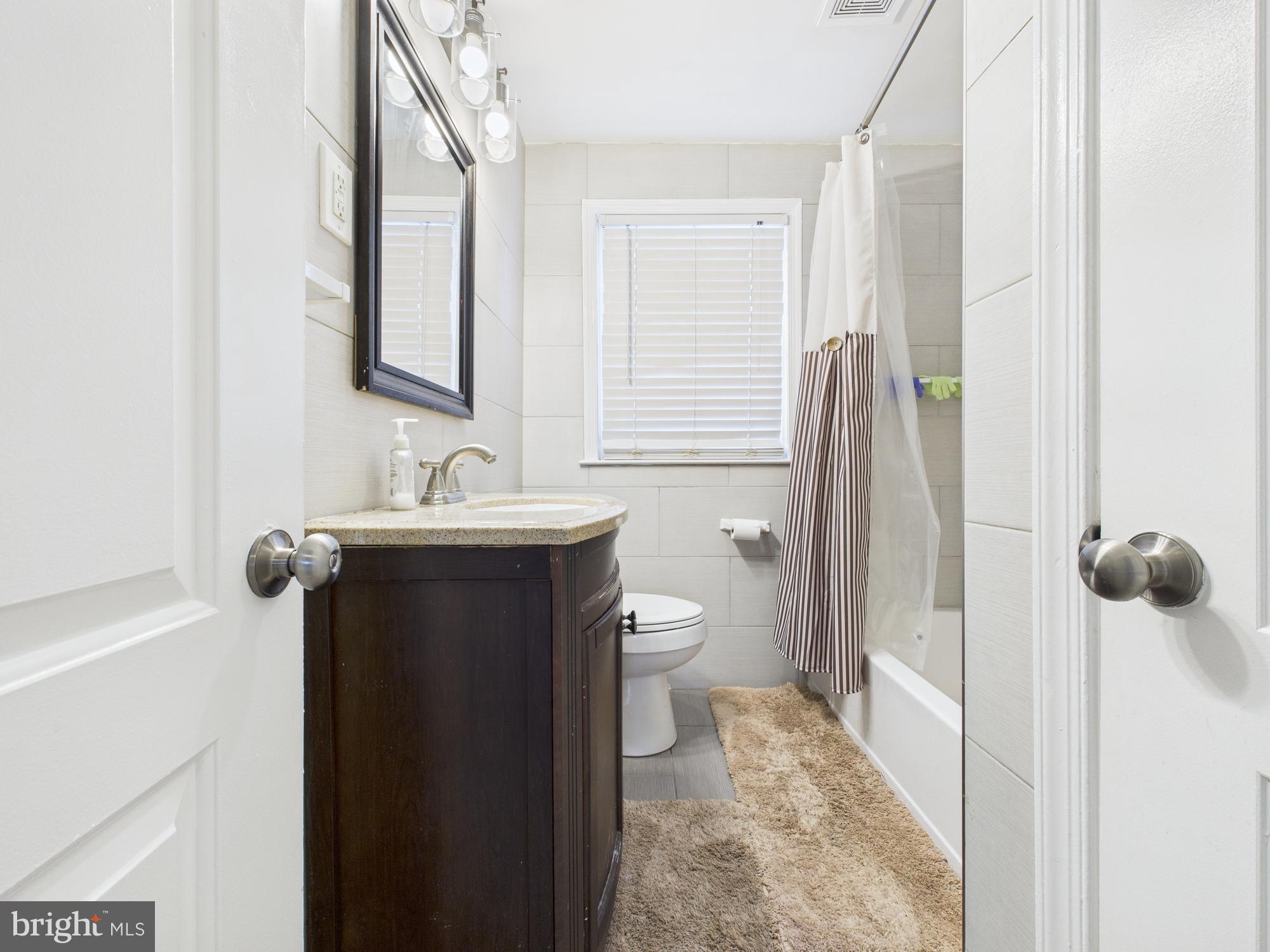 1551 Langford Road Baltimore, MD 21207 - Photo 50 of 52 a bathroom with a sink and a mirror