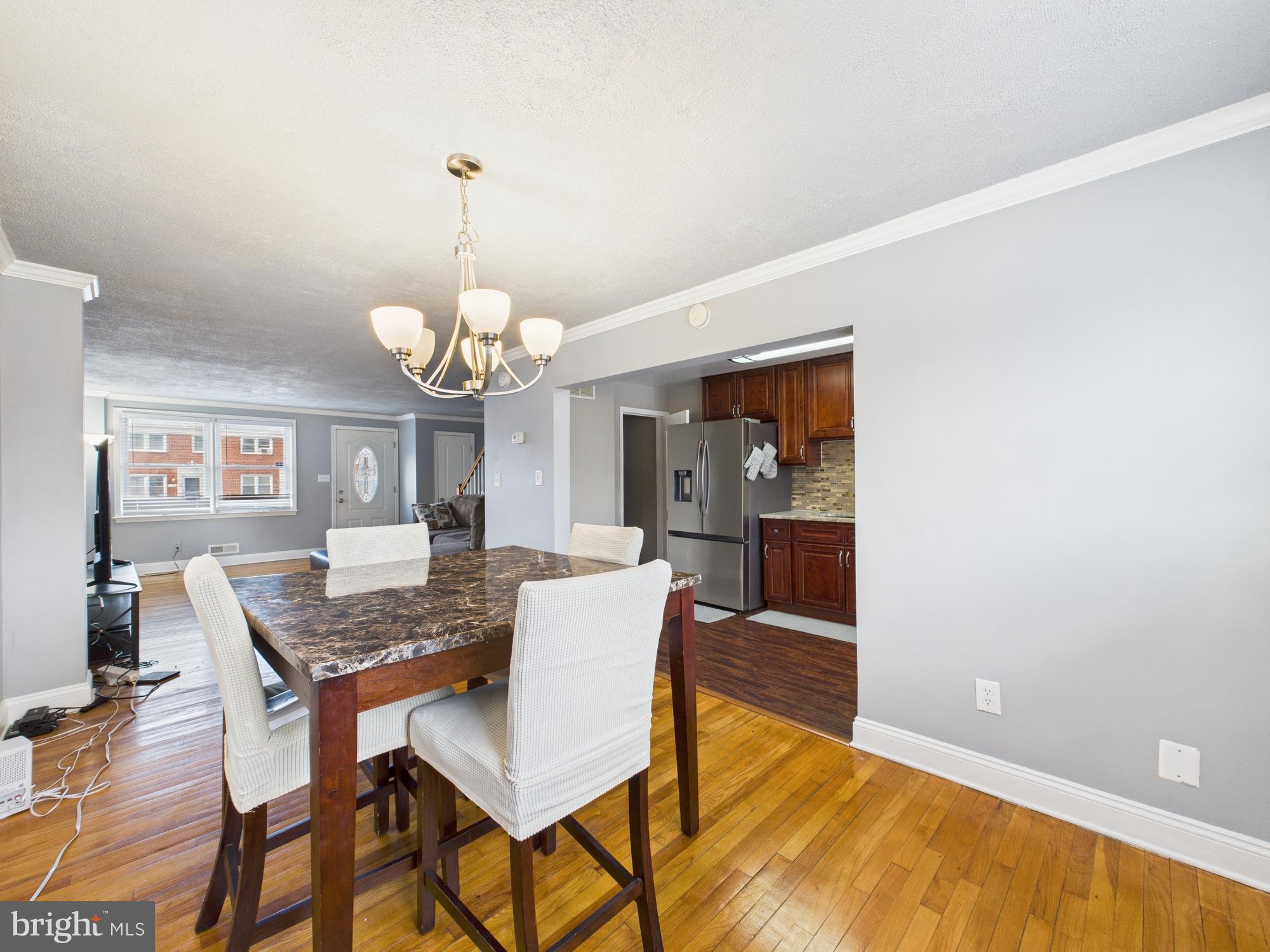 1551 Langford Road Baltimore, MD 21207 - Photo 10 of 52 a dining room with wooden floor and chandelier
