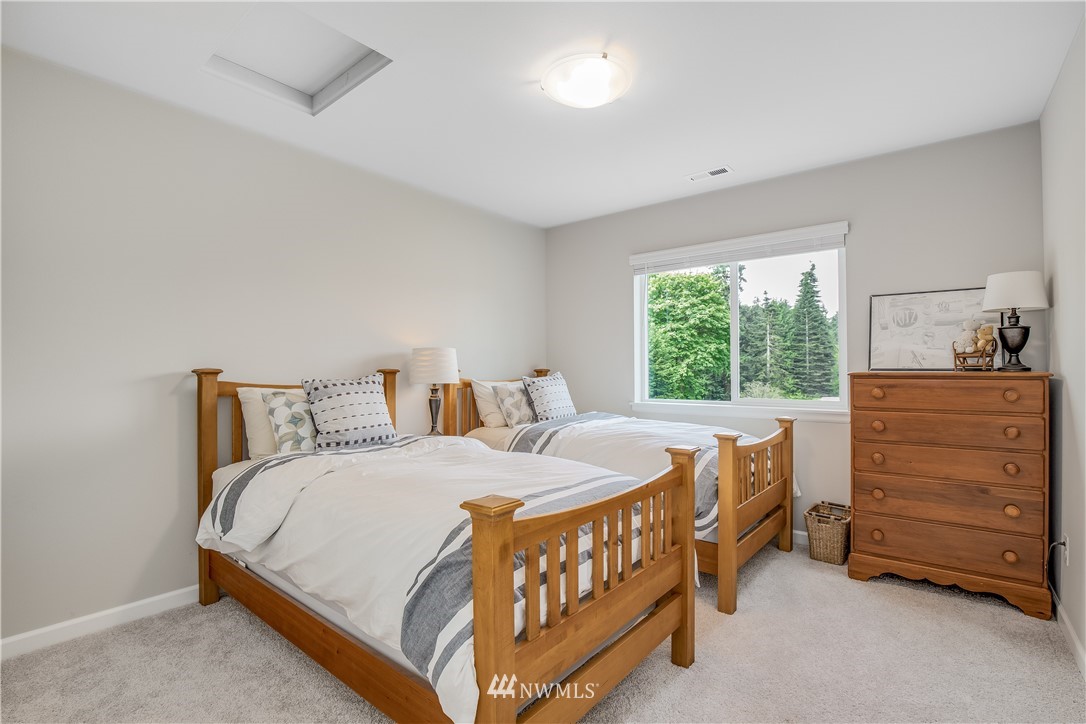 6319 Southeast 5th Place Renton, WA 98059 - Photo 22 of 25 a bedroom with a bed a dresser and a window