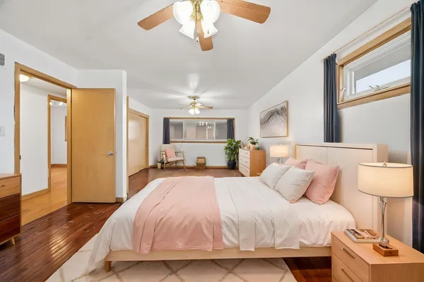a spacious bedroom with a bed and a lamp