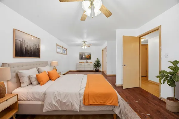 a bedroom with a bed and a chandelier