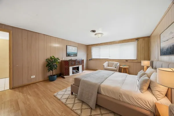 a bedroom with a bed furniture and a flat screen tv
