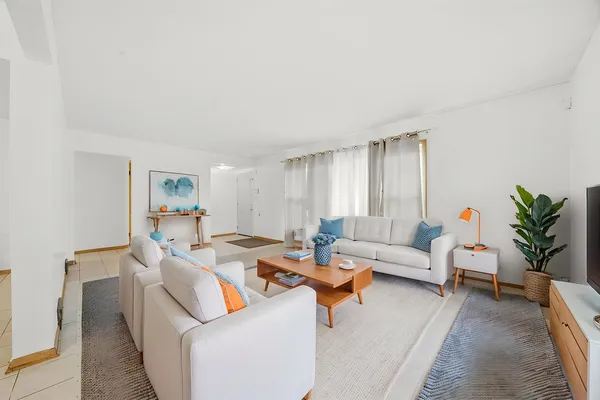 a living room with furniture and a large window