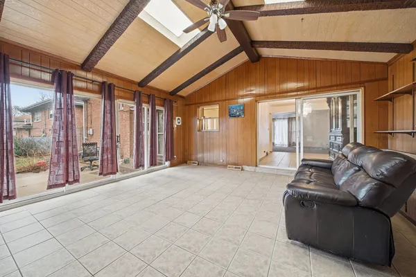 a living room with furniture and large windows