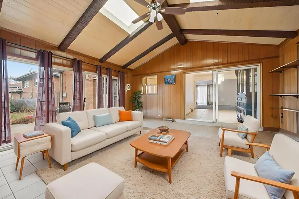 a living room with furniture a table and chairs