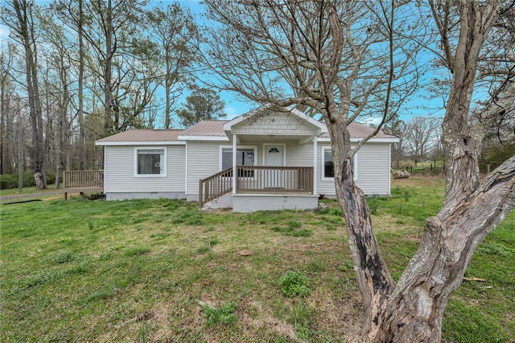 2573 Rockmart Road Villa Rica, GA 30180 - Photo 1 of 1 a backyard of a house with plants and large tree