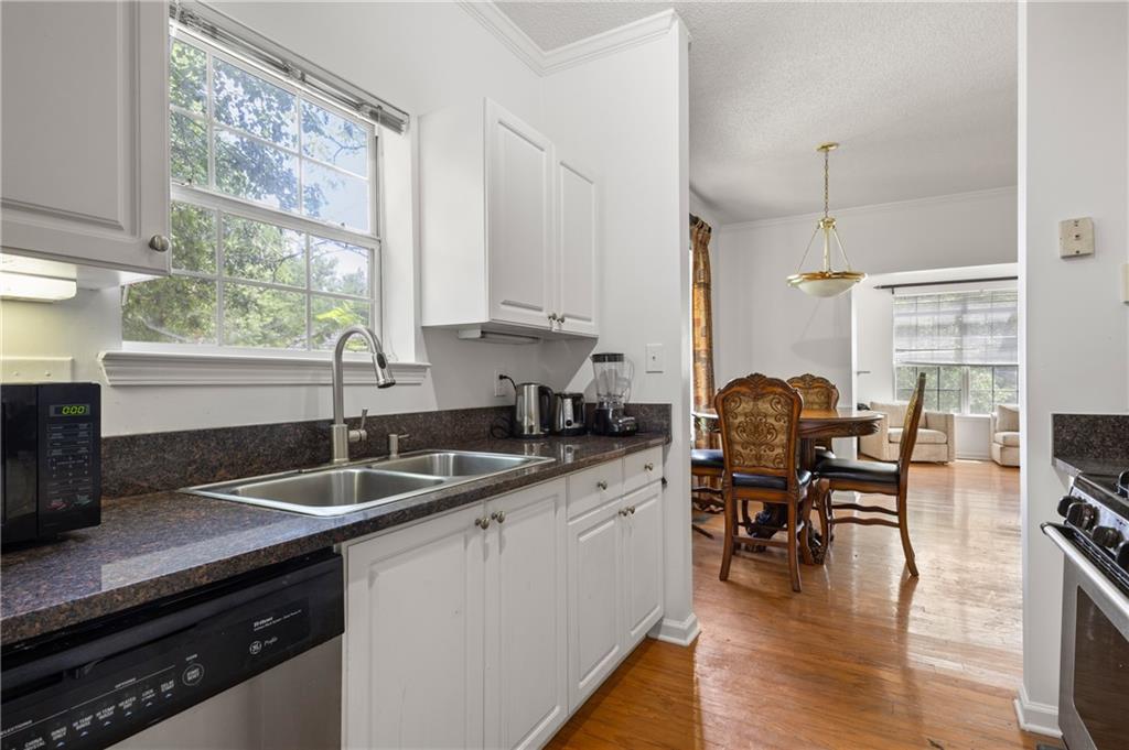 581 Cooper Street Southwest Atlanta, GA 30312 - Photo 11 of 26 a kitchen with a sink a counter and appliances