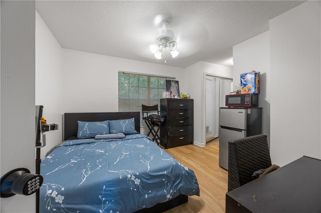 581 Cooper Street Southwest Atlanta, GA 30312 - Photo 17 of 26 a bed room with a bed and a television