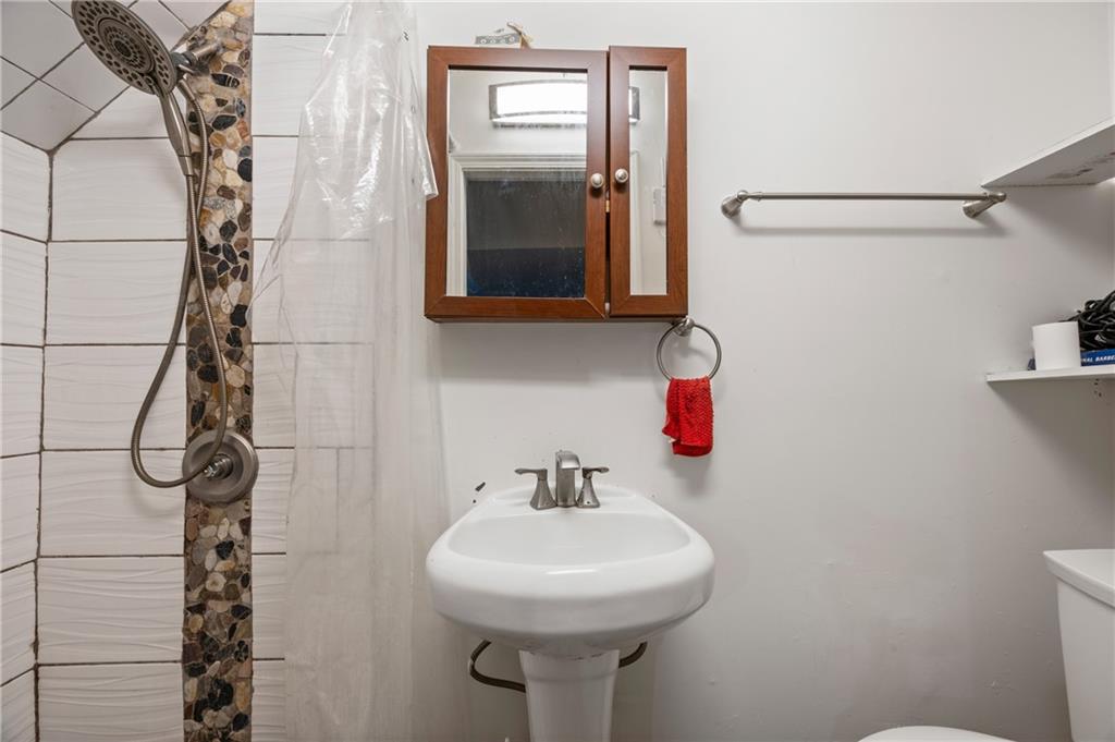 581 Cooper Street Southwest Atlanta, GA 30312 - Photo 23 of 26 a bathroom with a sink and mirror