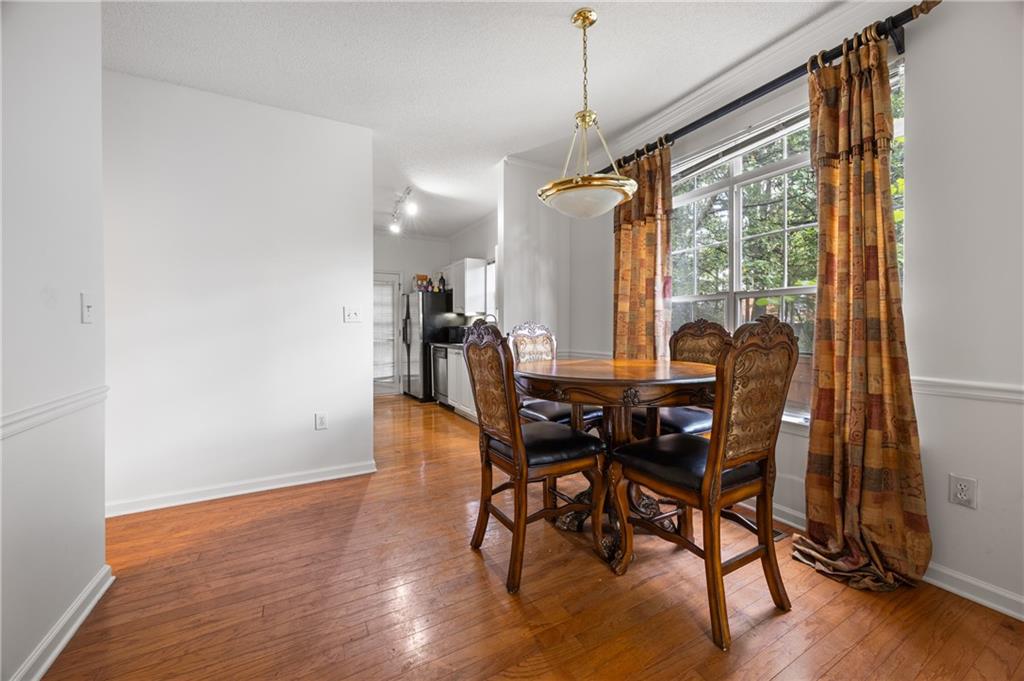 581 Cooper Street Southwest Atlanta, GA 30312 - Photo 9 of 26 a view of a dining room with furniture window and wooden floor