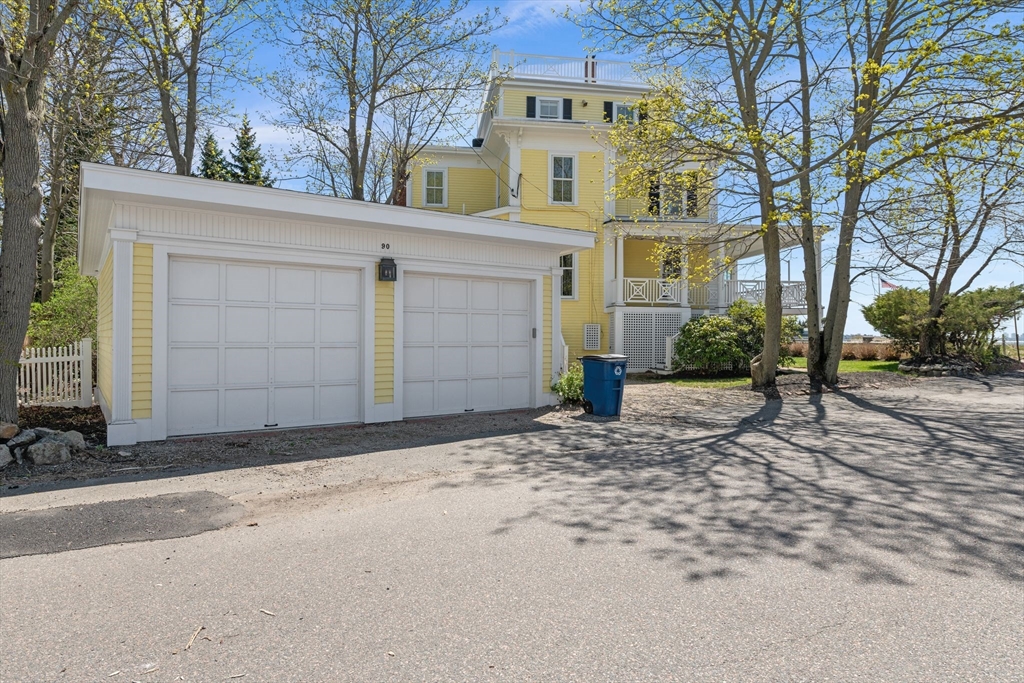 90 Puritan Road Swampscott, MA 01907 - Photo 3 of 42 a front view of a house with a yard and garage
