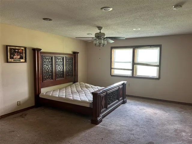 a bed sitting in a room next to a window